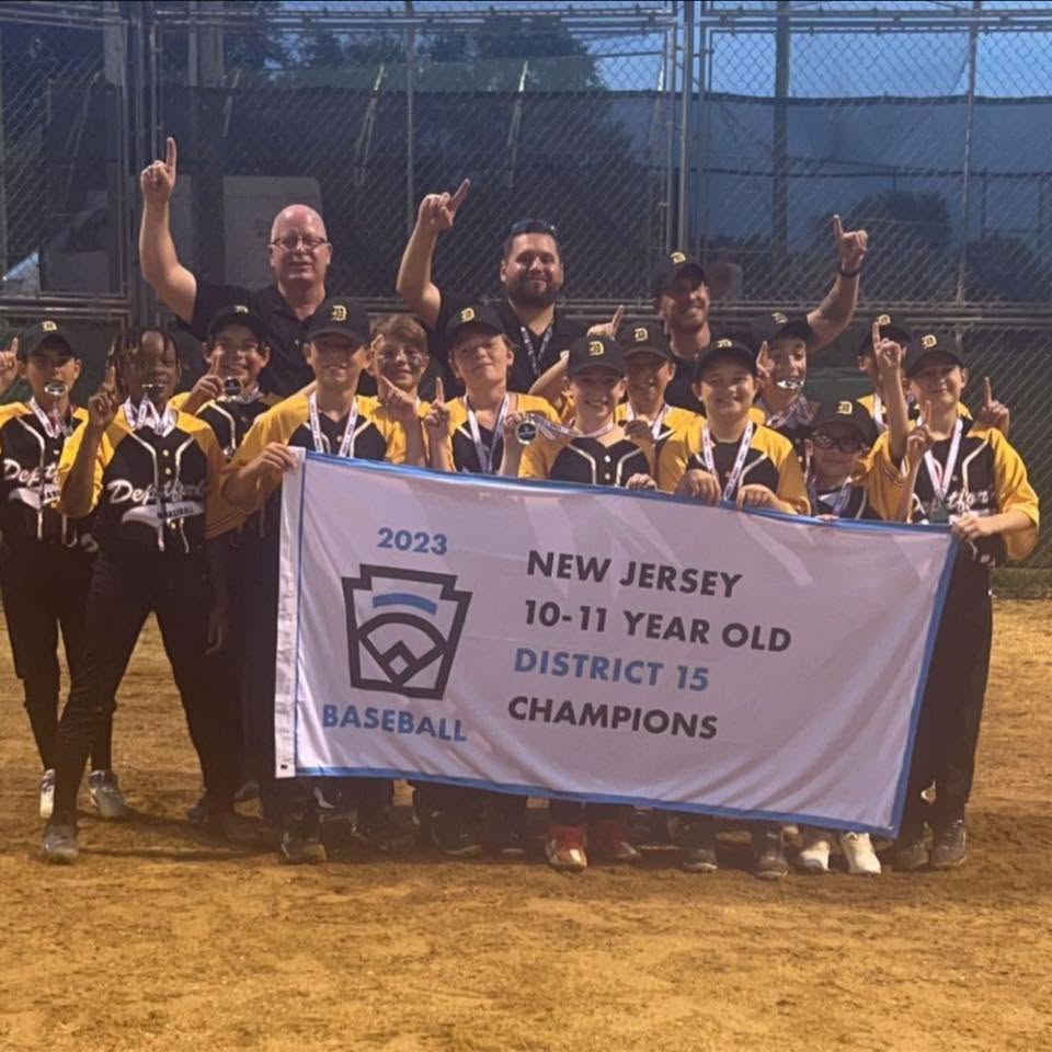 Coach Louis Gelsomini with the 2023 Deptford Little League 10–11 All-Star Team holding the New Jersey District 15 Championship banner